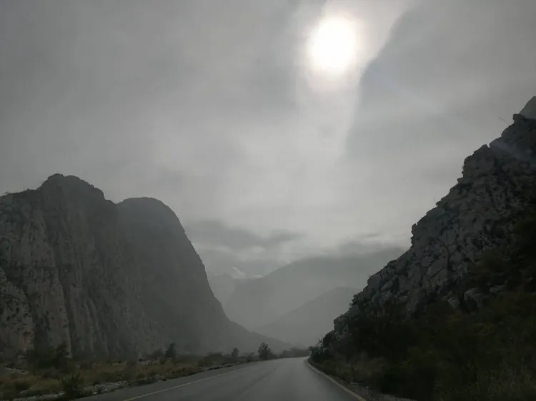 Road through a misty mountain canyon
