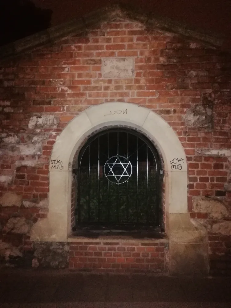 Arched brick gate at night